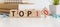 Top 10 sign made of wooden dices on a table i a bright environment