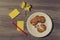 Top above close up overhead view photo of tasty homemade cookies broken bitten biscuits on white round plate with crumbled paper s