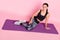 Top above high angle full body photo of young sportive girl happy smile sit mat rest training isolated over pink color