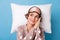 Top above high angle view photo of dreamy sleepy woman lie pillow look empty space  on blue color background