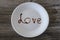 Top above overhead close up view photo of white round plate with write inscription i love you concept. A plate with word love on i