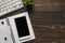 Top above overhead view photo of computer keyboard with plant open notebook on spiral binder clip notepaper and telephone cellular