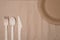 Top above overhead view photo of  wooden cutlery and a paper plate isolated on craft paper background table
