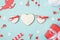 Top above view photo of tasty white cookies with secret messages and wishes on light blue desk with cupid wrapped package small