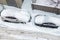 Top aerail view of apartment office building parking lot with many cars covered by snow stucked after heavy blizzard snowfall
