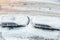 Top aerial view of apartment office building parking lot with many cars covered by snow stucked after heavy blizzard snowfall