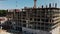 Top aerial view of a massive construction site with a house in a city