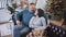 Top angle view of relaxed Caucasian husband and wife sitting on couch and talking on Christmas eve. Portrait of happy