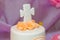 Top of cake with cream flowers and mastic cross for christening child party. Baptism candy bar