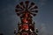 Top of Christmas windmill on dark sky background. Night Christmas lights of traditional wood carousel of nativity scenes in Berlin