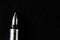 Top close up shot of one fountain pen nib in focus shot over black background -knowledge concept