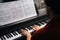 Top close-up view of hands of unrecognizable musician man playing on piano at home.