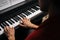 Top close-up view of hands of unrecognizable musician man playing on piano at home during lesson.