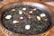 Top closeup of Arros Negre in a black pot on the wooden background