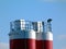 top detail of large steel drum cement silos in red and white