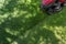 Top down above view of professional lawn mower worker cutting fresh green grass with landcaping tractor equipment