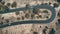 Top down aerial of cars drive winding highland road in mountain countryside in Cyprus