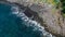 Top down aerial of traditional jukung boats resting on beach in Bali. Amed beach in Bali Indonesia with Jukung fishing