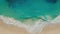 Top down aerial view of azure blue water, ocean waves breaking on sand beach