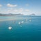 Top down aerial view of boats on the reef of tropical beach of Black River, Mauritius island