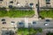 Top down aerial view of busy street with moving cars traffic and zebra road pedestrian crosswalk