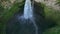 Top down aerial view drone descending and tilt up to reveal Coban Sriti waterfall, Java, Indonesia