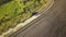 Top down aerial view of fast driving car on dirt road leaving cloud of dust behind.