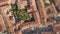 Top down aerial view of a small historic town Venzone in Northern Italy with red tiled roofs of old buildings.