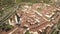 Top down aerial view of a small historic town Venzone in Northern Italy with red tiled roofs of old buildings.