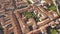 Top down aerial view of a small historic town Venzone in Northern Italy with red tiled roofs of old buildings.