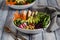 A top down close up view of a buddha bowl filled with various vegetables and grilled chicken. Healthy eating concept.