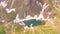 Top and down drone aerial view of the Lake Branchino an Alpine natural lake during spring season. Italian Alps. Italy
