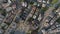 Top down footage of housing estate in city lit by late afternoon sunshine. Multistorey apartment buildings in