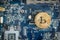 Top Down Gold Digital Cryptocurrency Coin on Computer Motherboard. Bitcoin Mining Concept. Crypto Currency Background.