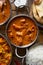 Top down image of indian butter chicken in balta dish