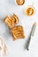 Top down vertical view of two pieces of toast with peanut butter and honey on a clear glass plate.