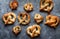 Top down view of an assortment of homemade baked pretzels with various toppings.