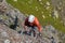 Top down view of climber on iron steps going upwards on via ferrata Delle Trincee in Dolomites, Italy, on a bright sunny day