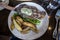 Top down view of a delectable steak frites dinner on a wooden table inside a restaurant