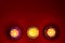Top down view of earthen lamps burning against red background