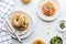 Top down view of Everything bagels with salmon lox, cream cheese and garnished with capers and sprouts.