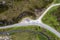 Top down view of a gray campervan parked next to a small road in the middle of nowhere in the Scottish Highlands