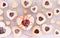 Top down view of heart shaped Linzer cookies filled with raspberry preserves for Valentine`s Day, on a cooling rack.