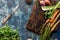 Top down view of herbs and vegetables used to prepare mirepoix.