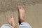 Top down view of male feet waiting for a wave to come in, oh the anticipation copy space too