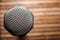 Top-Down View of A Microphone Head and Silver Grille on A Striped Yellow and Black Bamboo Mat Background. Karaoke Bar. Copy Space