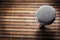 Top-Down View of A Microphone Head and Silver Grille on A Striped Yellow and Black Bamboo Mat Background. Karaoke Bar, Party