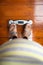 Top down view of an obese women wearing sandals standing on top of a weighing scale