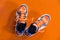 Top down view of orange and white badminton sport shoes on the o