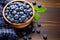 Top down view of organic wild blueberries in a wooden bowl